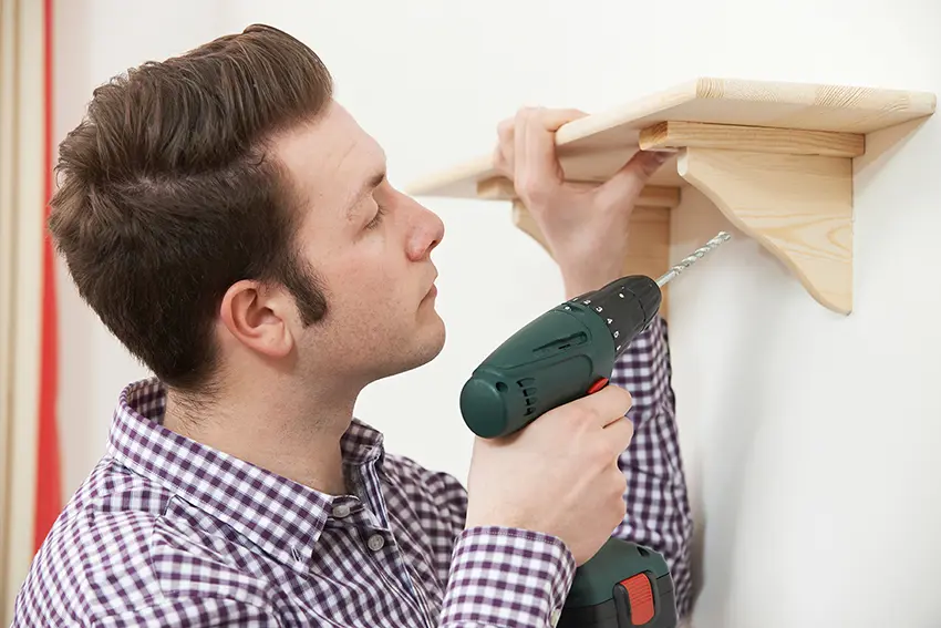Man Putting Up Shelf