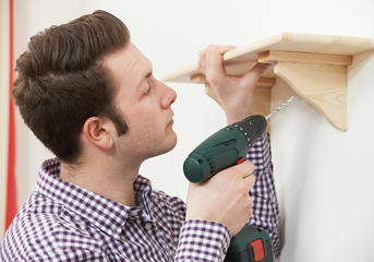 Man Putting Up Shelf