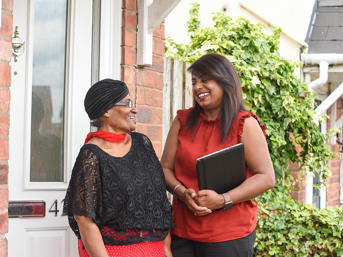 A customer laughs with a Wolverhampton Homes team member