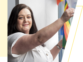 A Wolverhampton Homes team member puts up rainbow bunting for Wolverhampton Pride