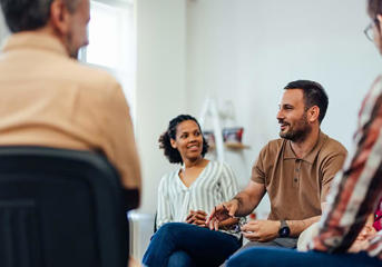 Group of adults sitting in a circle having a discussion