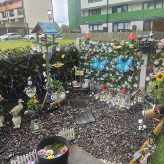 A small front garden with lots of ornaments 