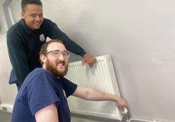 Two Wolverhampton Homes operatives check a radiator