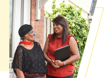 A customer and Wolverhampton Homes team member, looking at each other and smiling