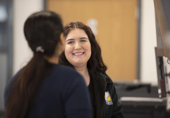 A Wolverhampton Homes team member smiles at a colleague