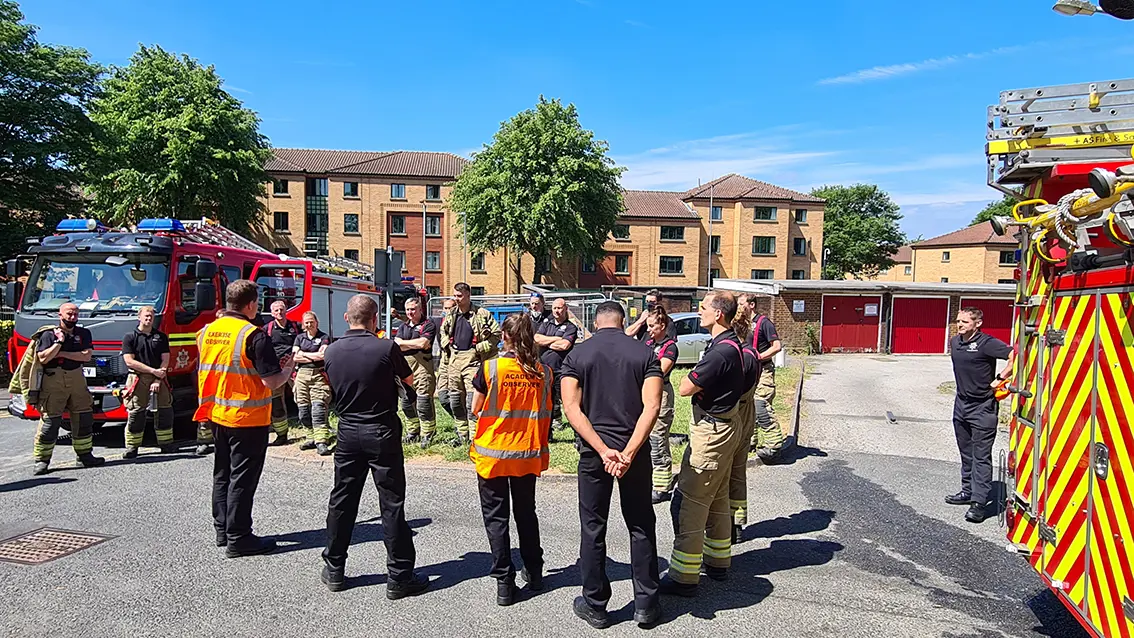 Officers from West Midlands Fire Service have a debrief after a fire safety exercise