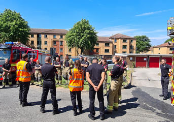 Officers from West Midlands Fire Service have a debrief after a fire safety exercise