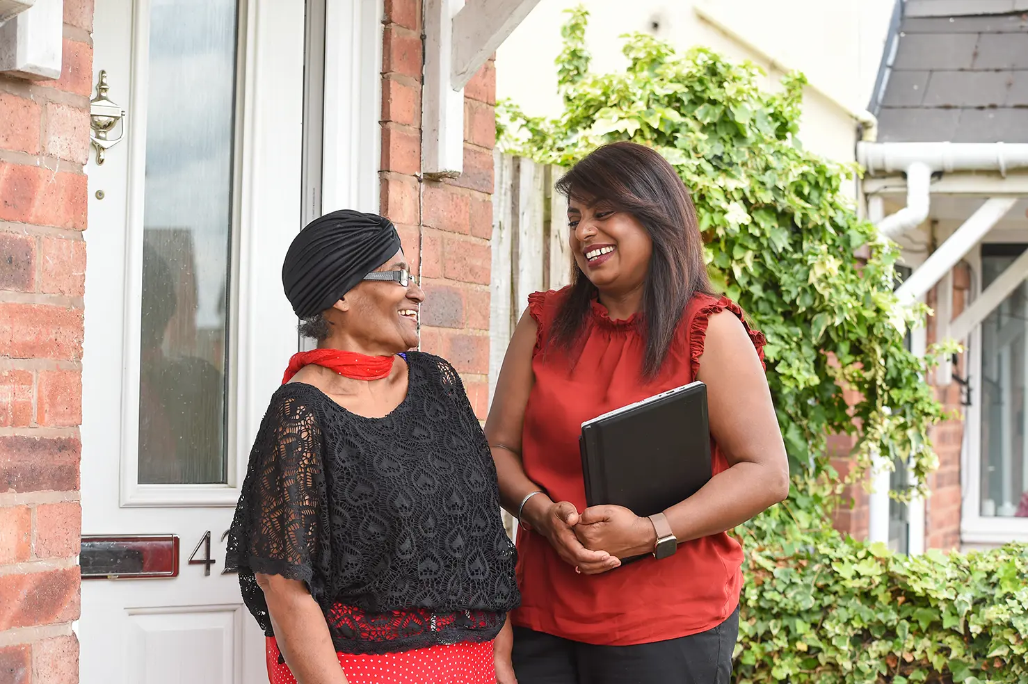 A Wolverhampton Homes team member talks to a customer on the doorstep