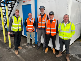 Five men from United Living, wearing hi-vis jackets, in Heath Town