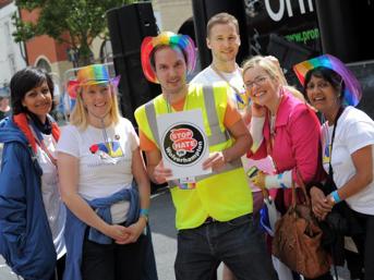 Group of people smiling at a Pride event
