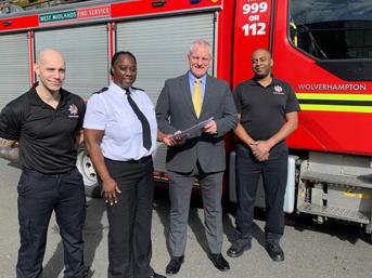 Wolverhampton Homes Building Safety Manager with three people from West Midlands Fire Service  