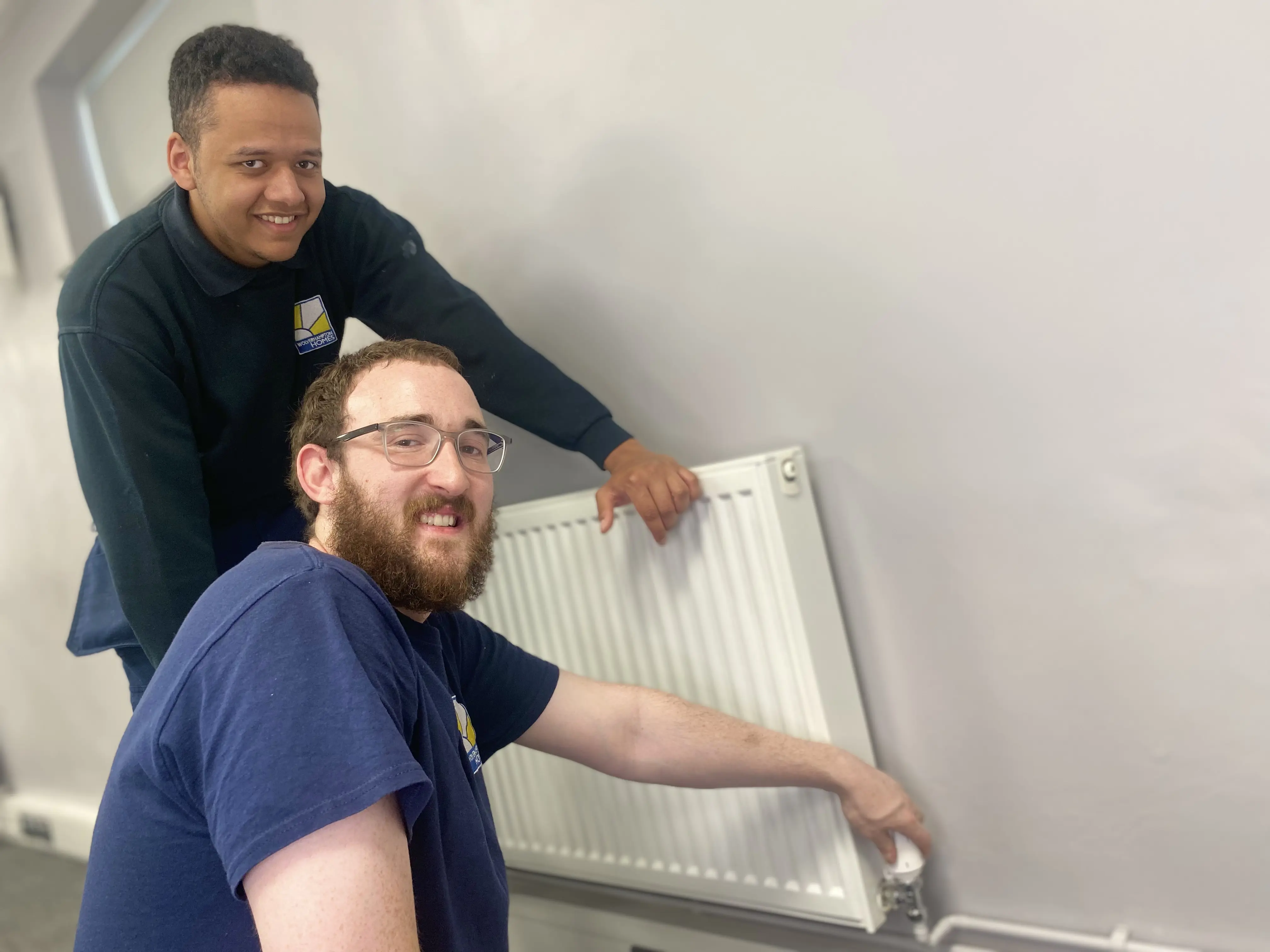 Two Wolverhampton Homes apprentices check a radiator
