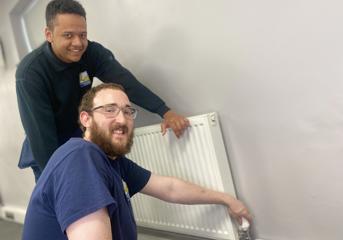 Two Wolverhampton Homes apprentices check a radiator