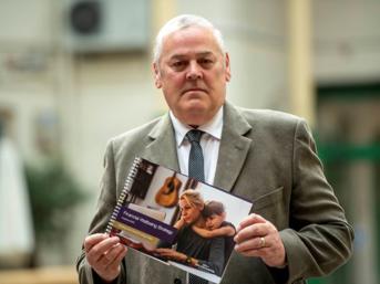 Person holding a booklet about financial wellbeing