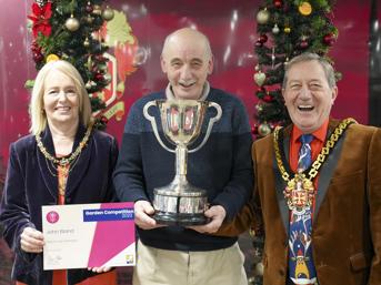 Garden competition winner holding trophy