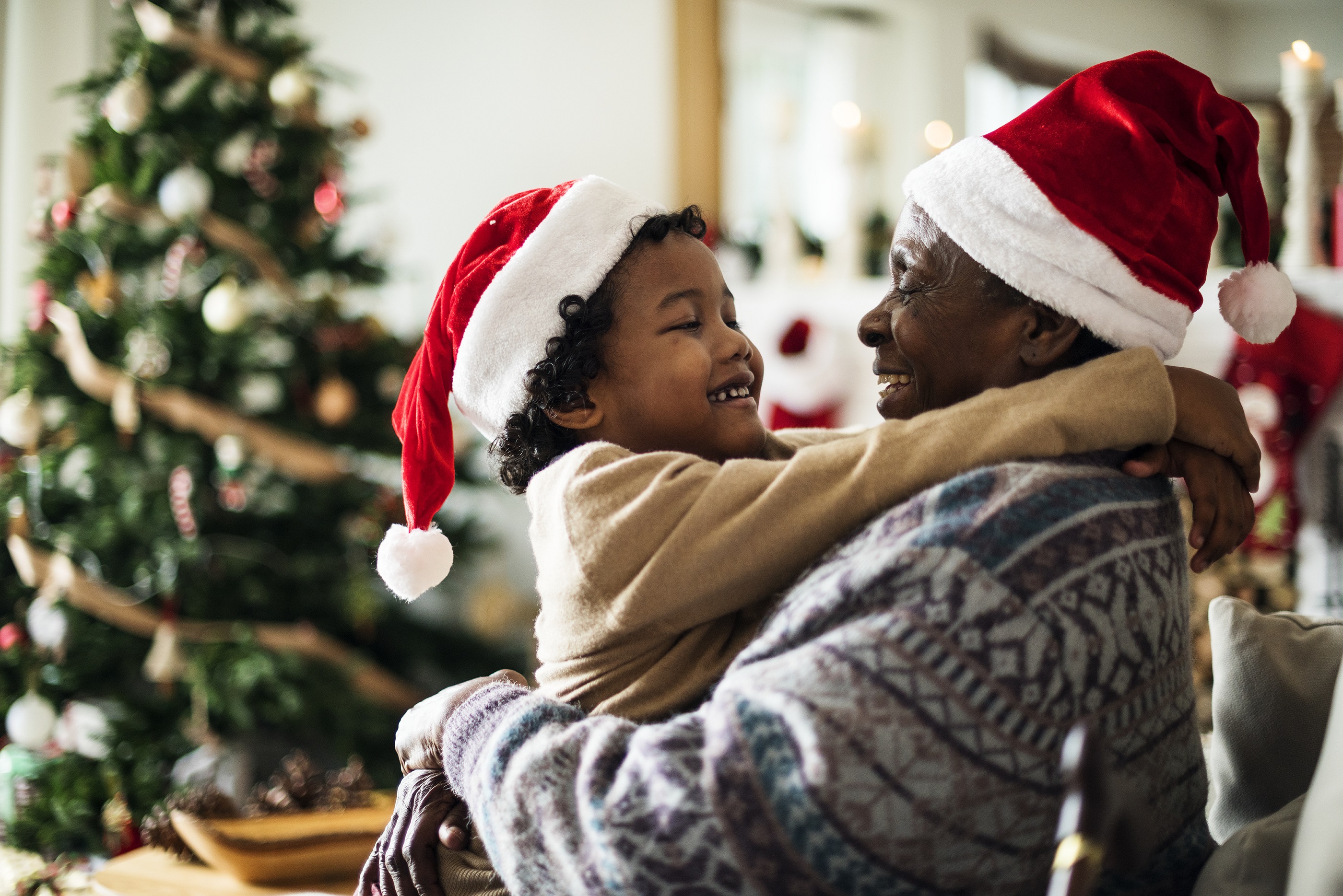 Man with child wearing christmas hats