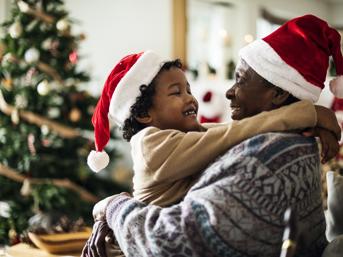 Man with child wearing christmas hats