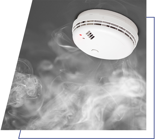 A smoke alarm with smoke around it