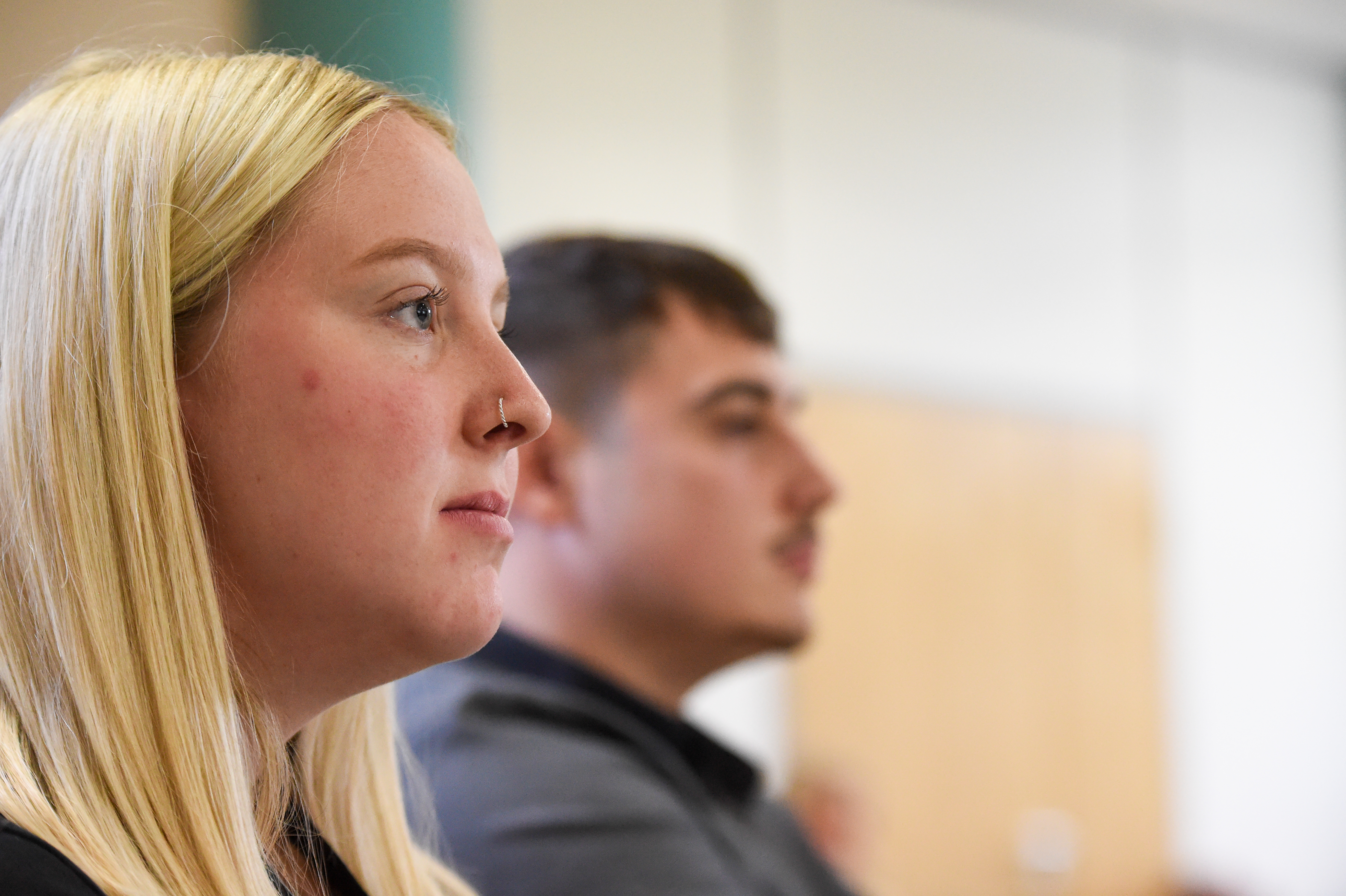 A woman with blonde hair looks to the right