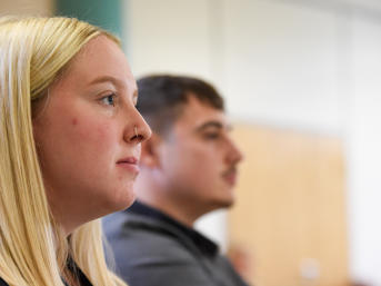 A woman with blonde hair looks to the right