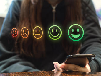 Stock image of five emojis with smiley faces to sad faces 