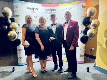 Four team members wearing formal clothing at the Juniper Awards