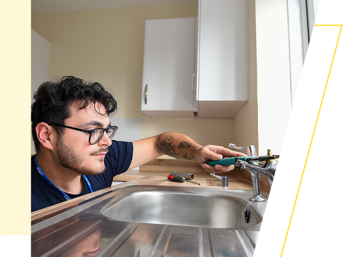 A Wolverhampton Homes operative fixes a kitchen sink