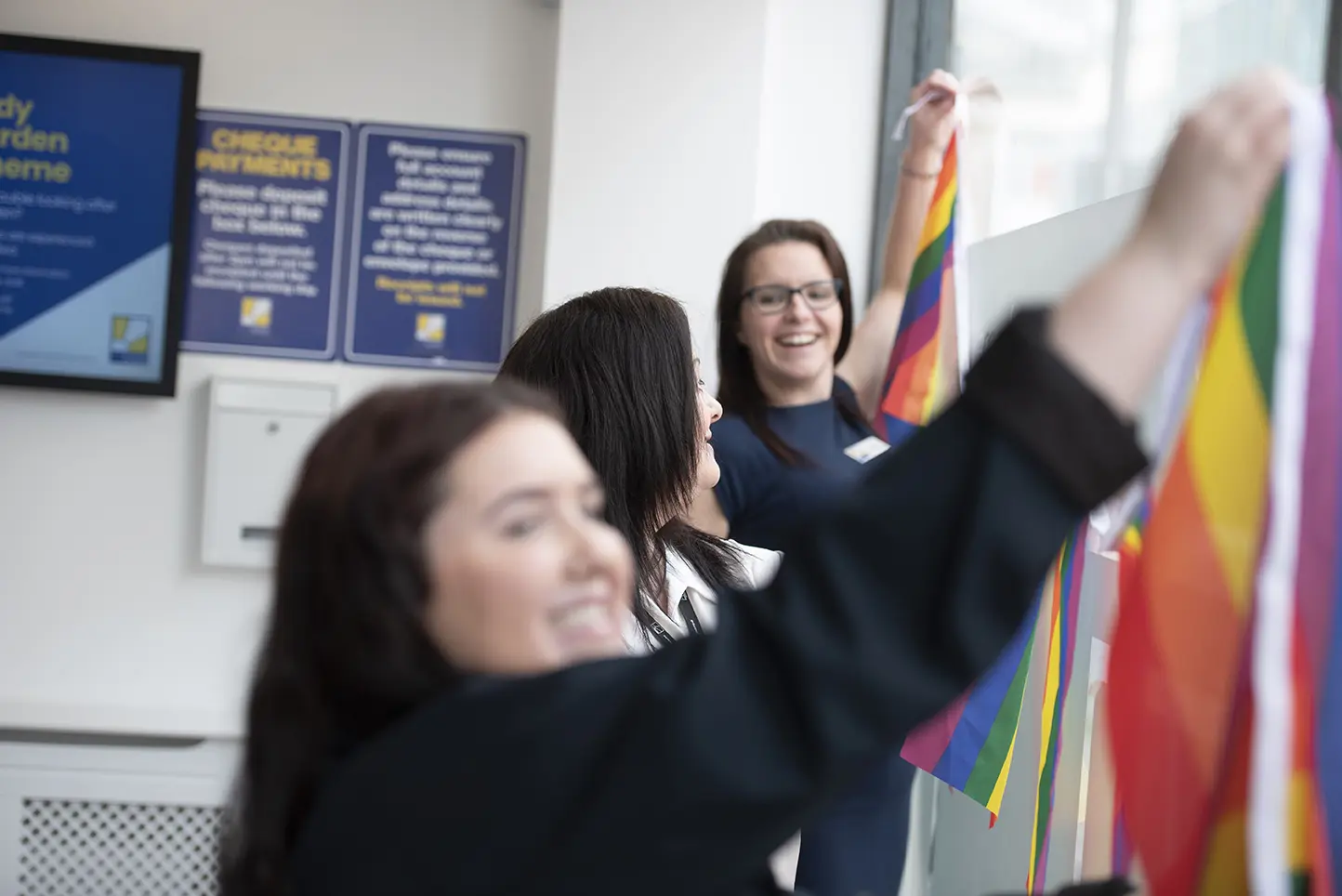 Wolverhampton Homes team members put up rainbow bunting for Wolverhampton Pride