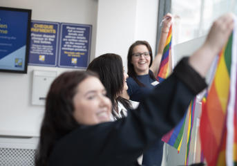 Wolverhampton Homes team members put up rainbow bunting for Wolverhampton Pride