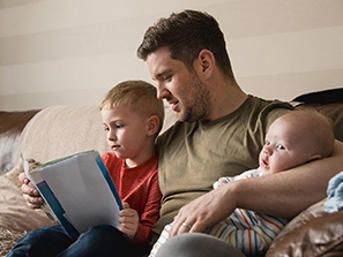 Dad with kids on a sofa
