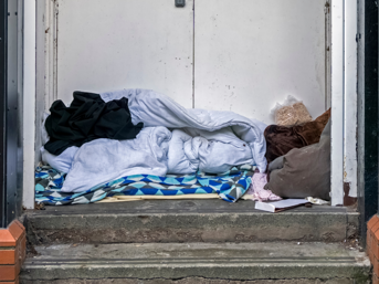 Blankets made into a bed in a doorway