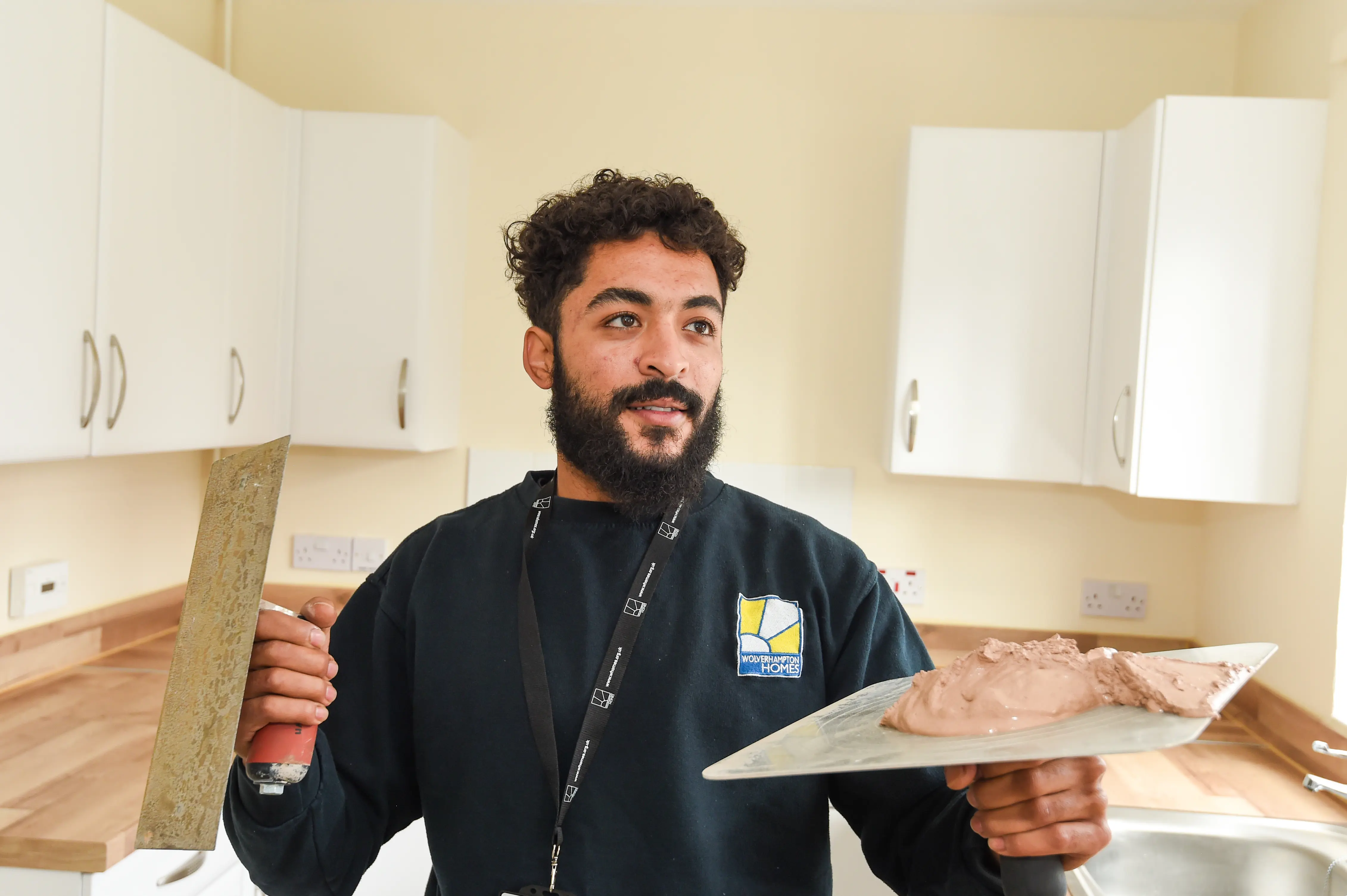 A Wolverhampton Homes operative gets ready to plaster a kitchen