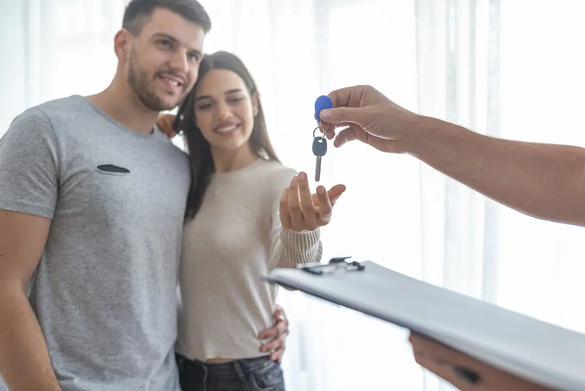 A man and a woman take the keys to a home