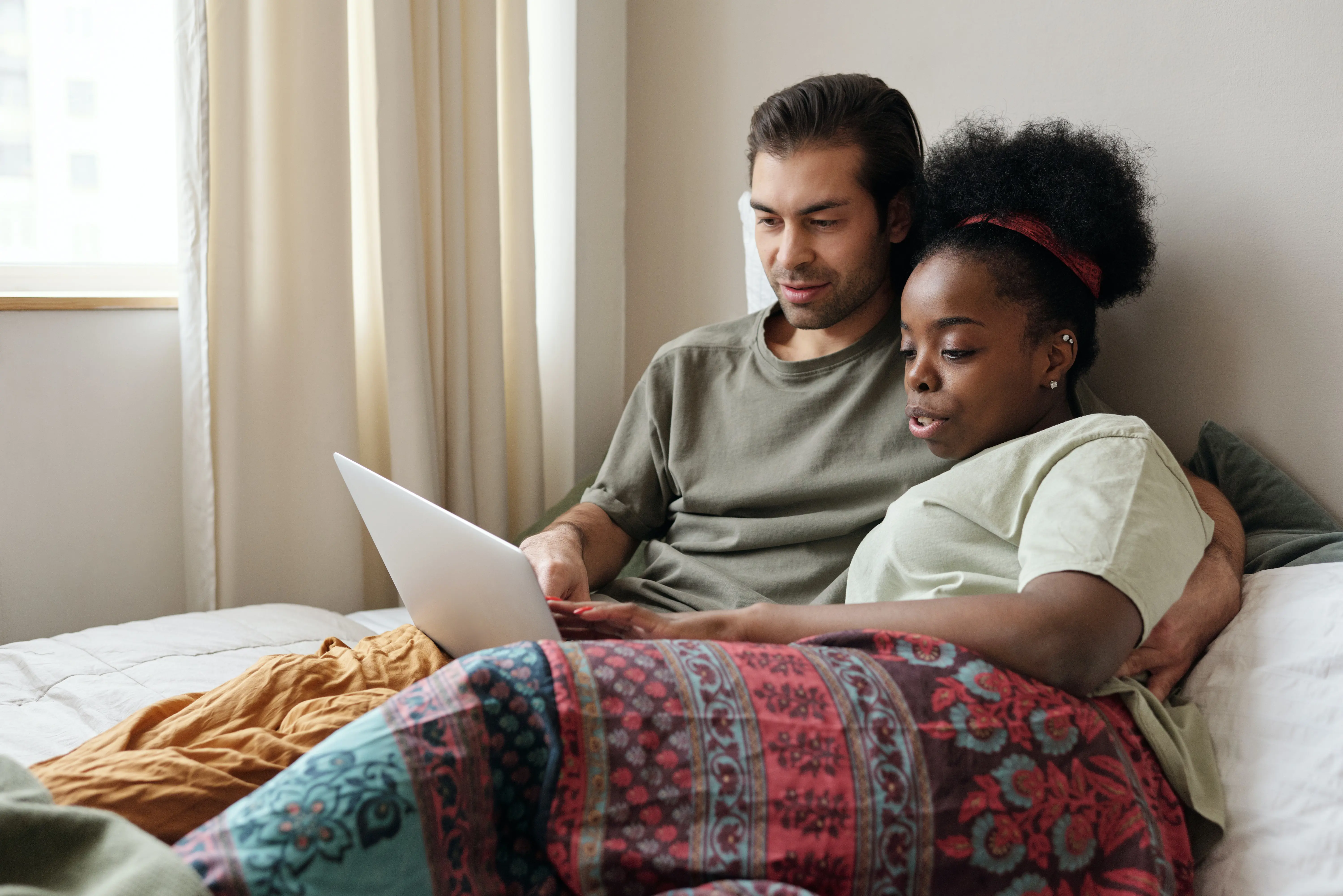Two people sitting together reading a document