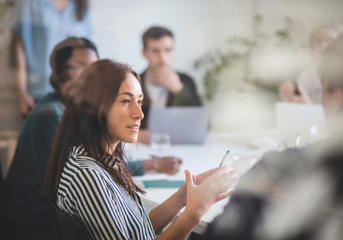 Woman speaking and gesturing during a group discussion