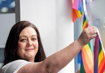 A Wolverhampton Homes team member puts up bunting for Wolverhampton Pride