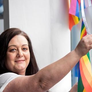A Wolverhampton Homes team member puts up bunting for Wolverhampton Pride