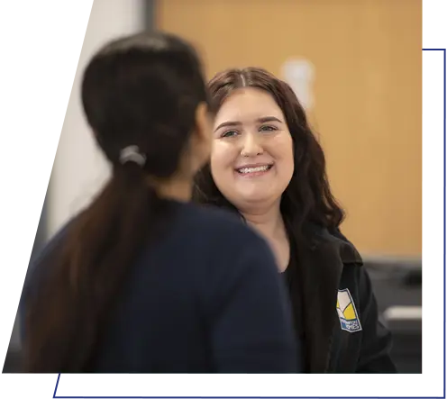 A Wolverhampton Homes team member smiles at a colleague