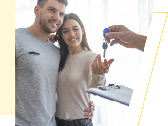 A couple take the keys to their new home
