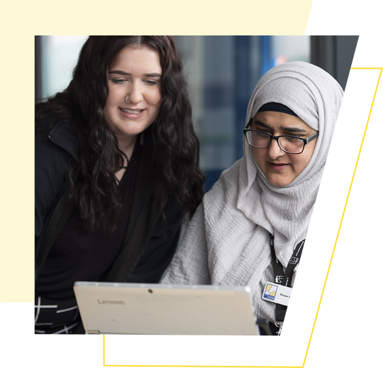 Two Wolverhampton Homes team members work at a laptop