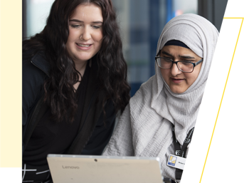 Two Wolverhampton Homes team members work at a laptop