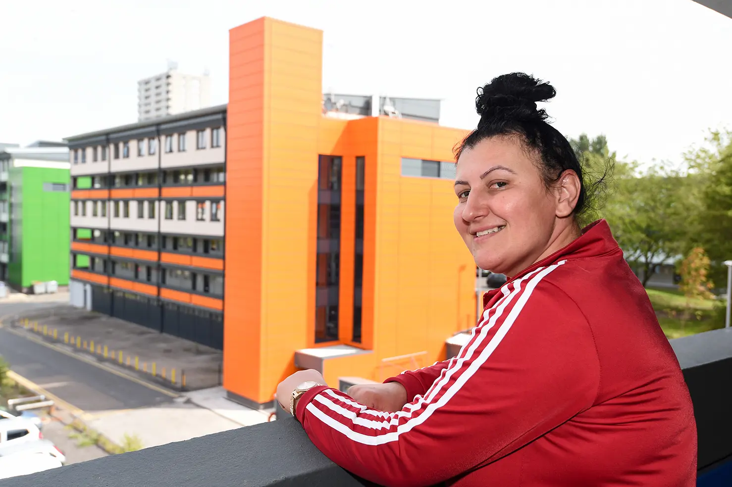 A Wolverhampton Homes customer stands on a walkway at flats in Heath Town 