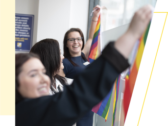 Wolverhampton Homes team members put up rainbow bunting for Wolverhampton Pride