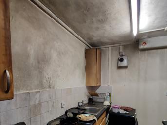 Kitchen showing smoke and fire damage to walls and ceiling