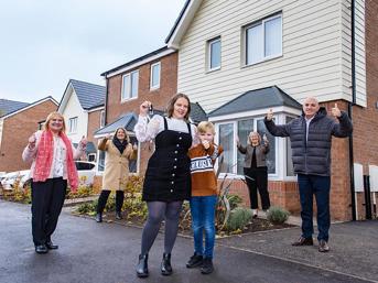 A family moving into their new home, with Wolverhampton Homes and council team members