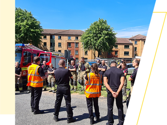 West Midlands Fire Service team members have a debrief after a fire safety exercise