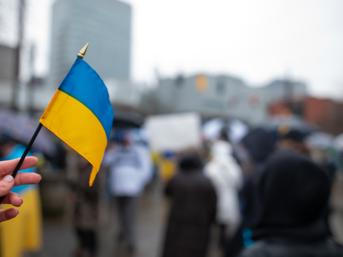 Someone holding a small Ukraine flag