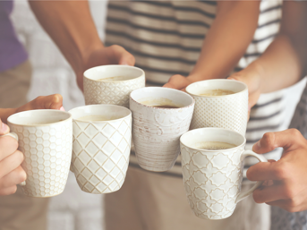People holding white mugs