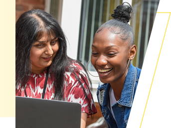 A customer and a Wolverhampton Homes team member look at a laptop