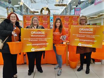 Four officers from Wolverhampton Homes and the City of Wolverhampton Council attend an Orange Wolves event in the Mander Centre